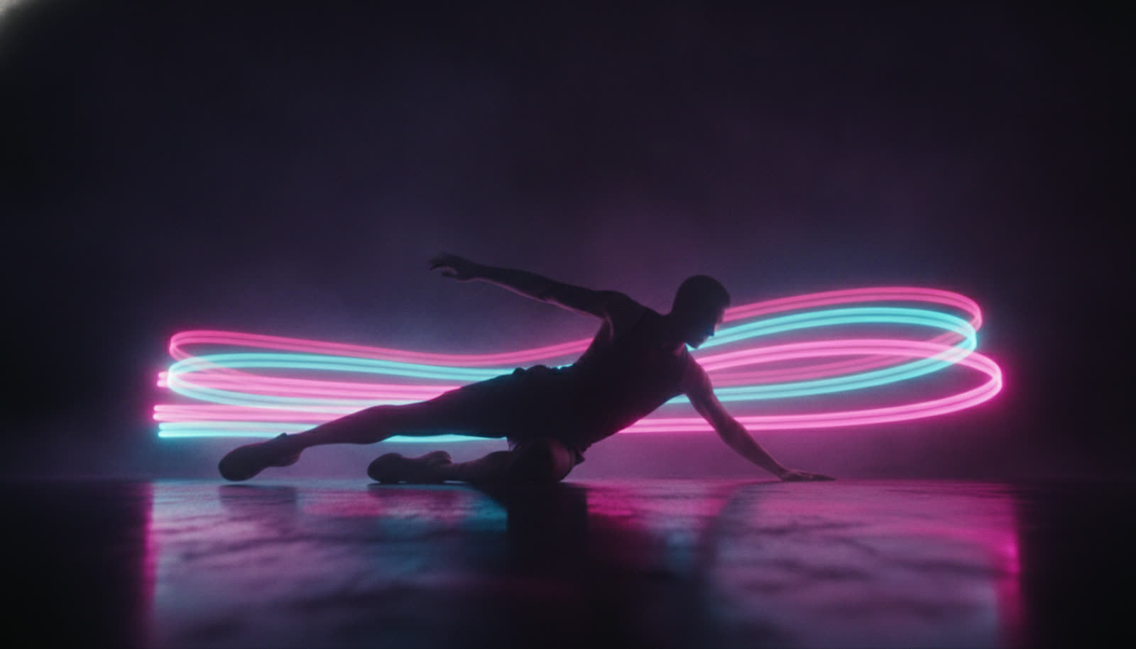 Athletic silhouette mid-slide with neon speed trails